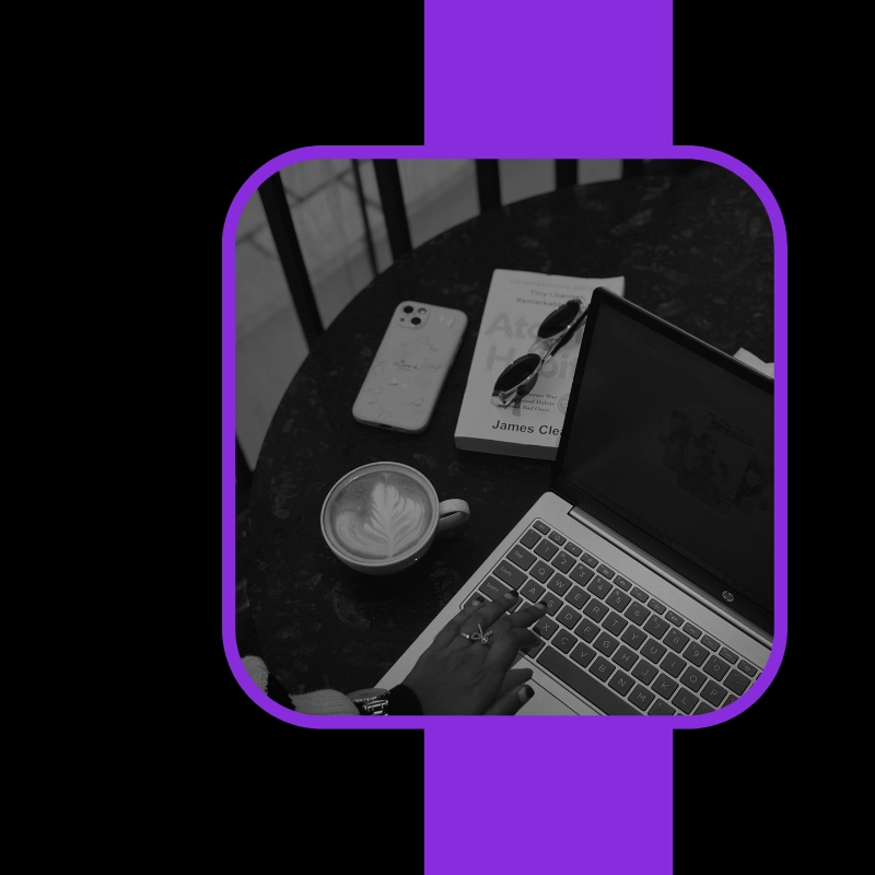 Creative workspace with a laptop, smartphone, glasses, and coffee cup symbolizing strategy and innovation by the best digital marketing analyst in Kuwait